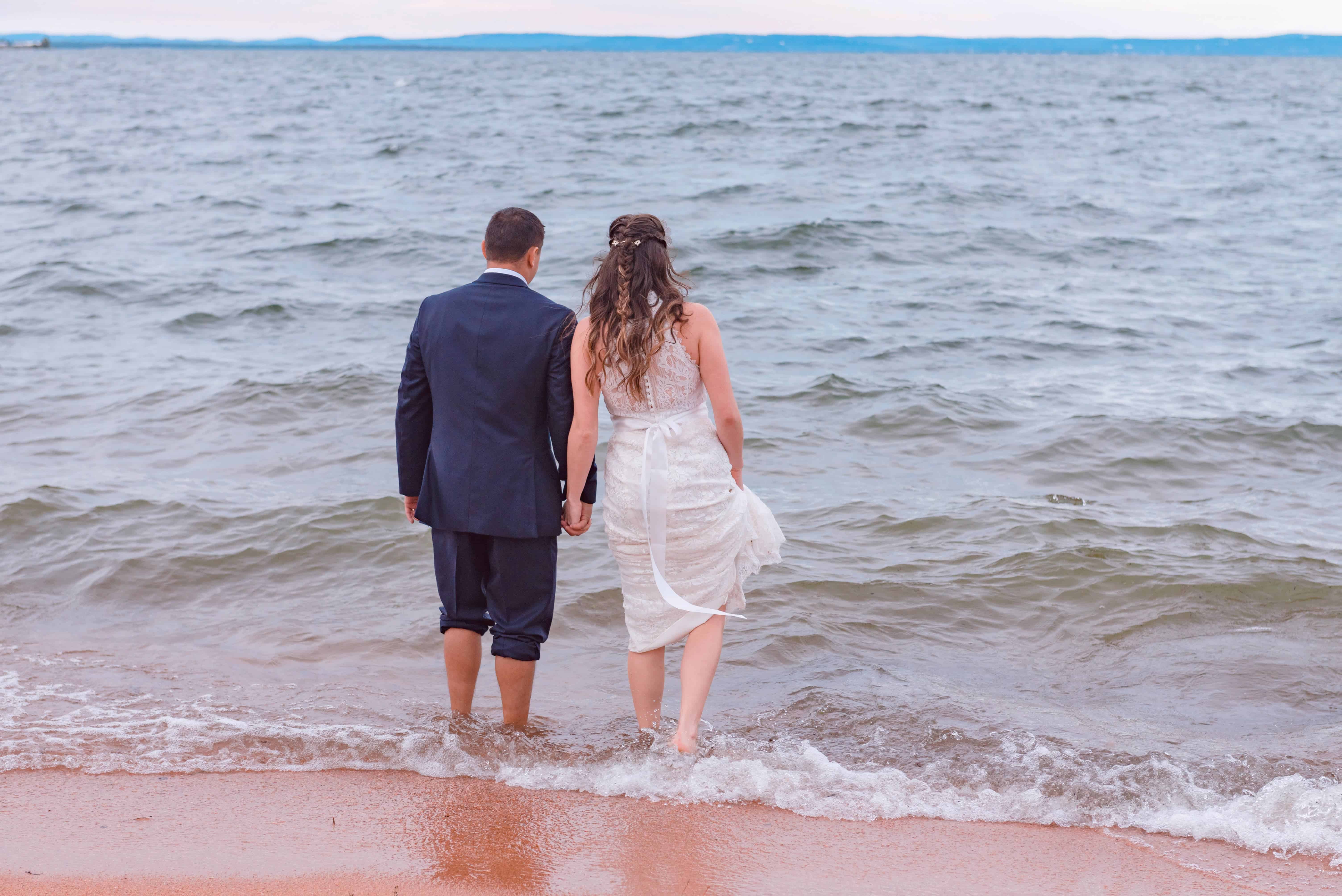 Image of couple who had their wedding at our texas hill country resort walking into Lake Buchanan