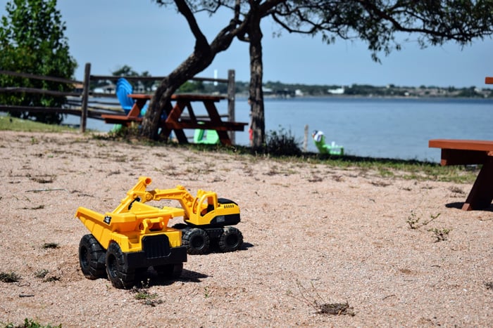 Image of trucks on the beach at one of the best vacation spots in Texas for families, Willow Point Resort!