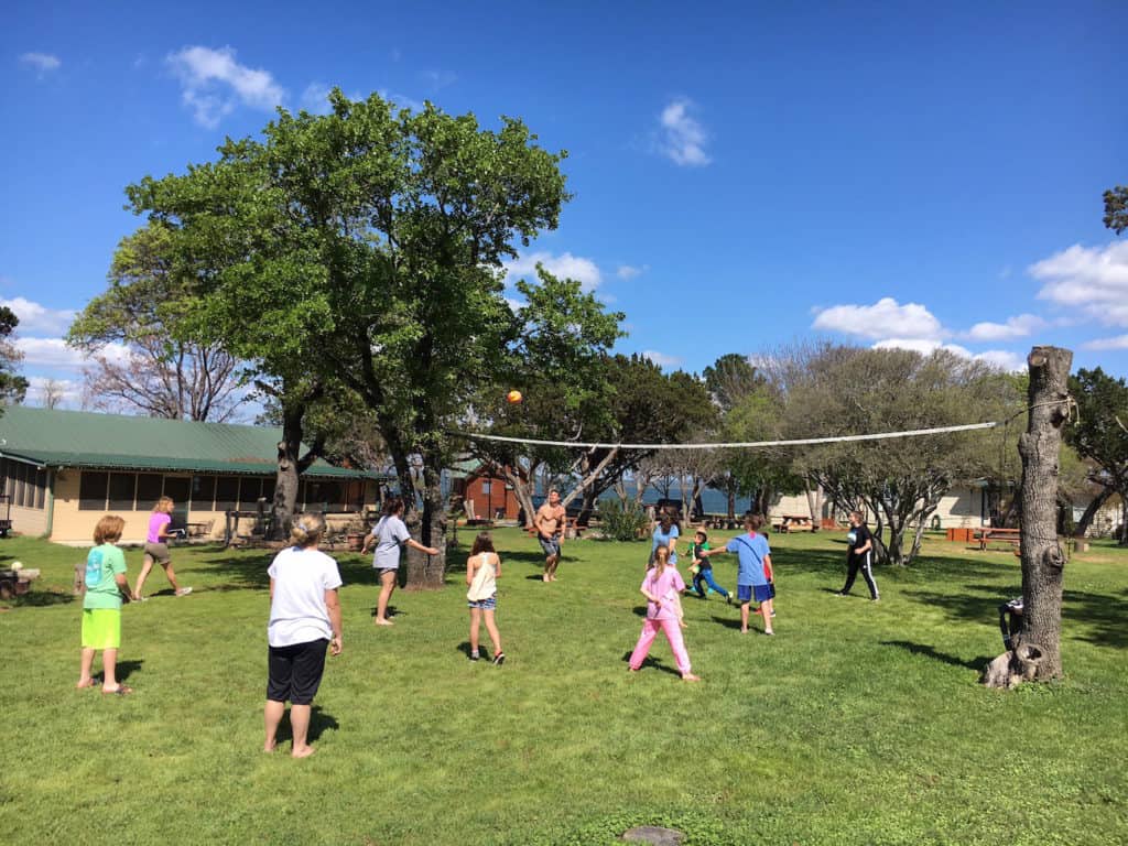 Image of guests playing volleyball at our Hill Country Resort property. Best cabin rentals in Texas are here at Willow Point. Best family friendly cabins in Texas.