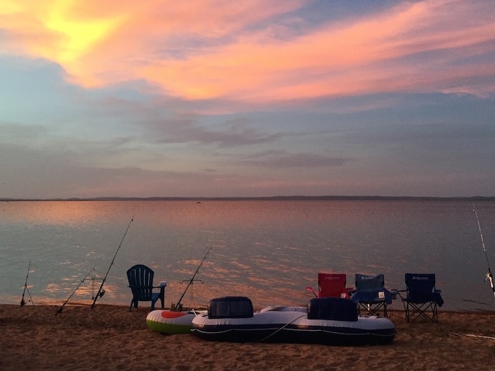 Image of sunset taken from our sandy lake beach at the best family friendly resort in Texas - Willow Point. Our lake cabin rentals are situated on the shores of Lake Buchanan in the heart of the Texas Hill Country.