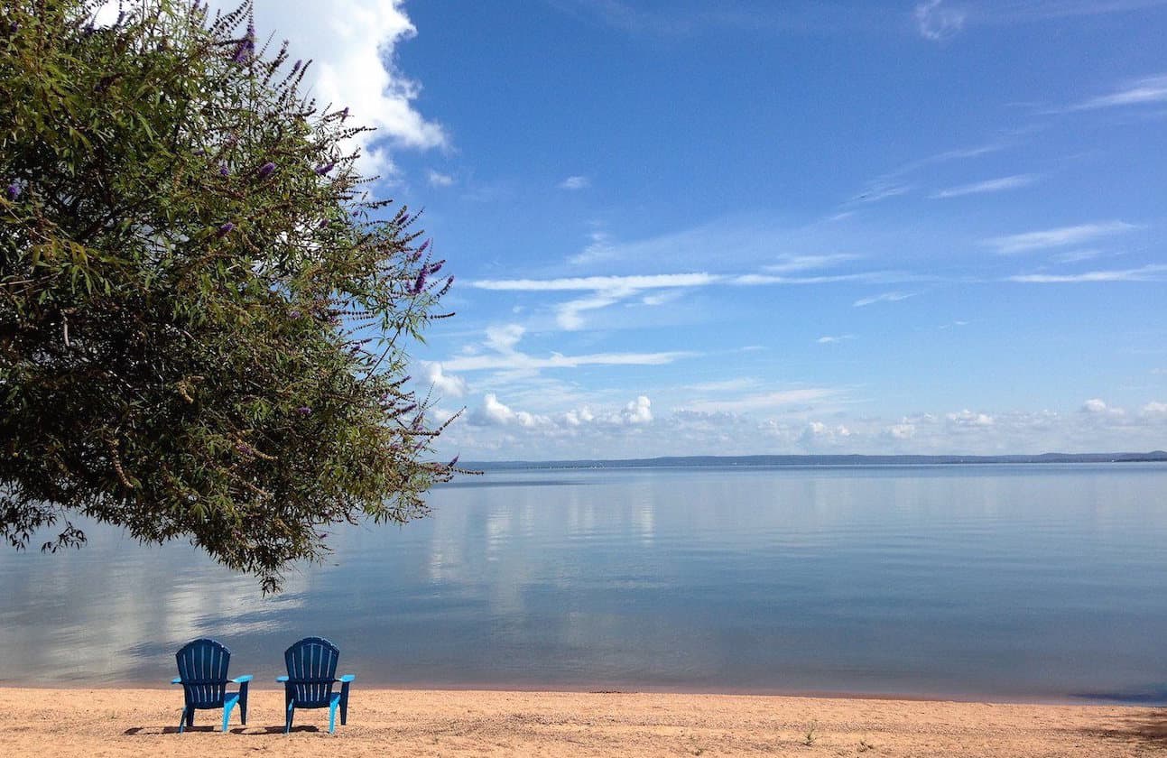 Image of beach chairs in front of Lake Buchanan in the Texas Hill Country at Willow Point Resort. Our lake cabin rentals are situated just feet from the lake