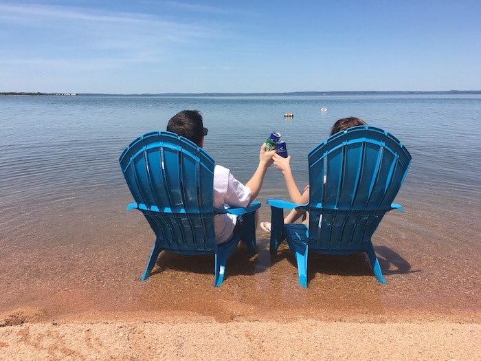 Image of guests sitting in chairs relaxing at the best texas vacation spots on Lake Buchanan