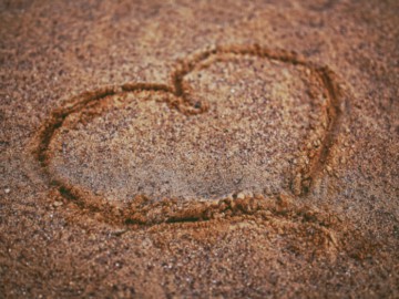 Image of heart drawn in sand at our romantic cabin rentals in Texas.