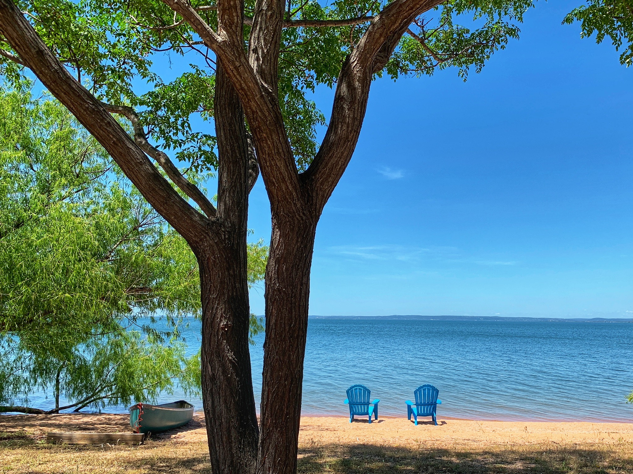 Image of empty beach chairs on the shores of Lake Buchanan at our Texas lake resort