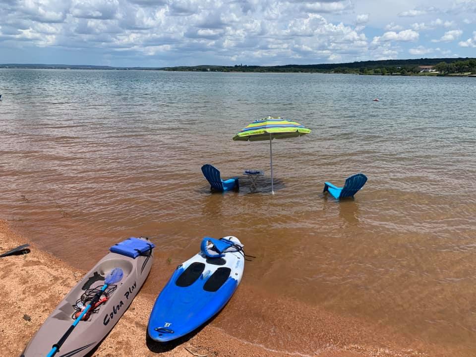 Image of boat rentals and chairs in the water at Willow Point