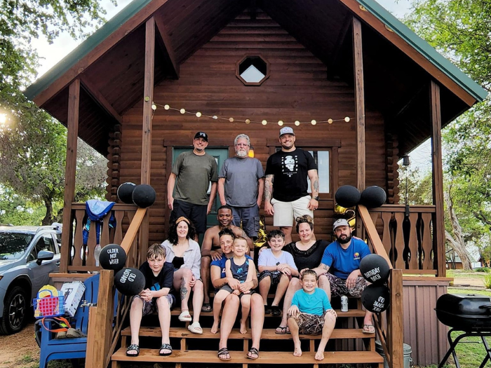 Image of guests gathered outside of one of our lakefront vacation rentals for a group photo.